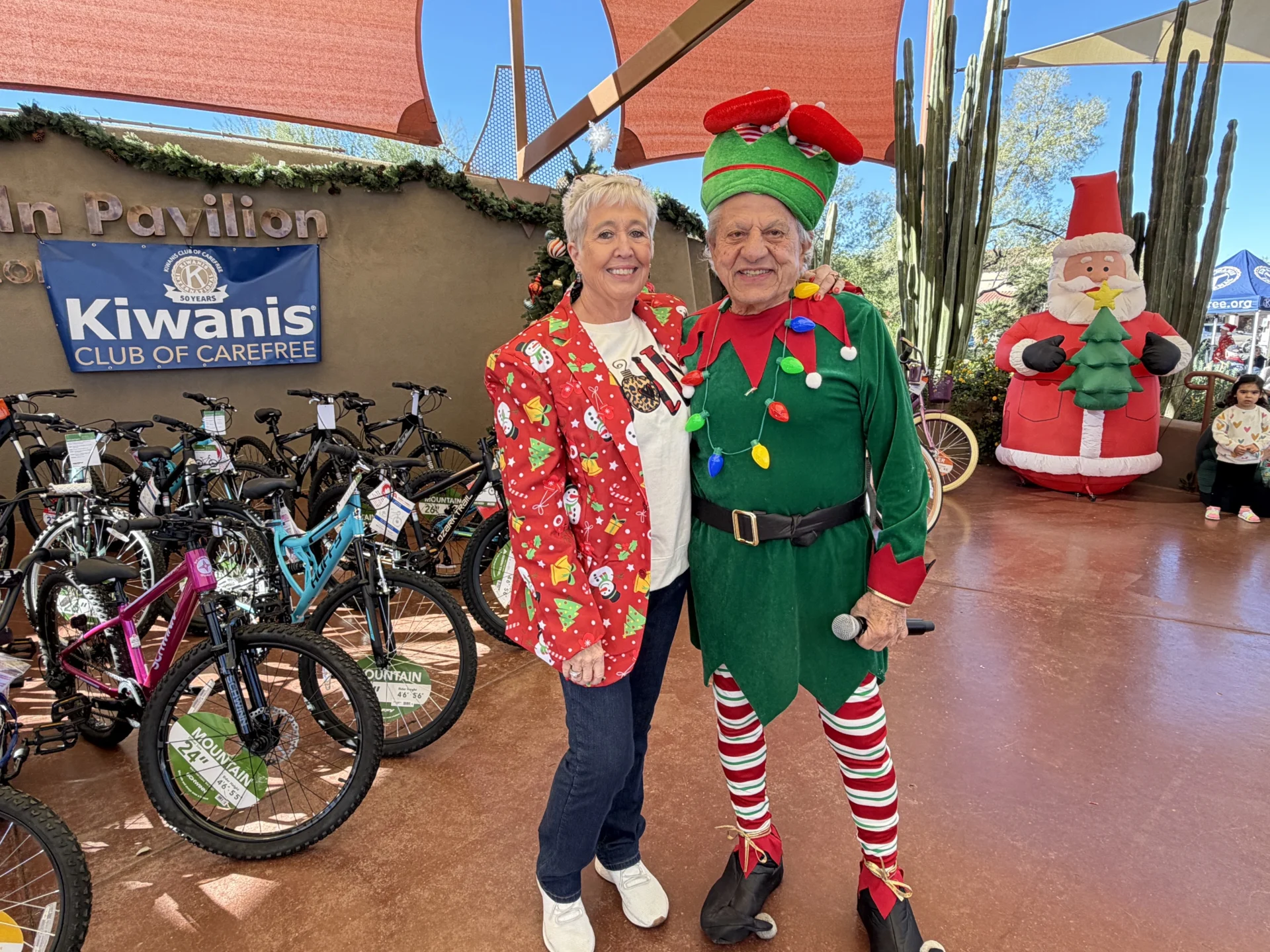 Elf and his helper at Kiwanis Christmas -Geno Orrico and Debbie Keller
